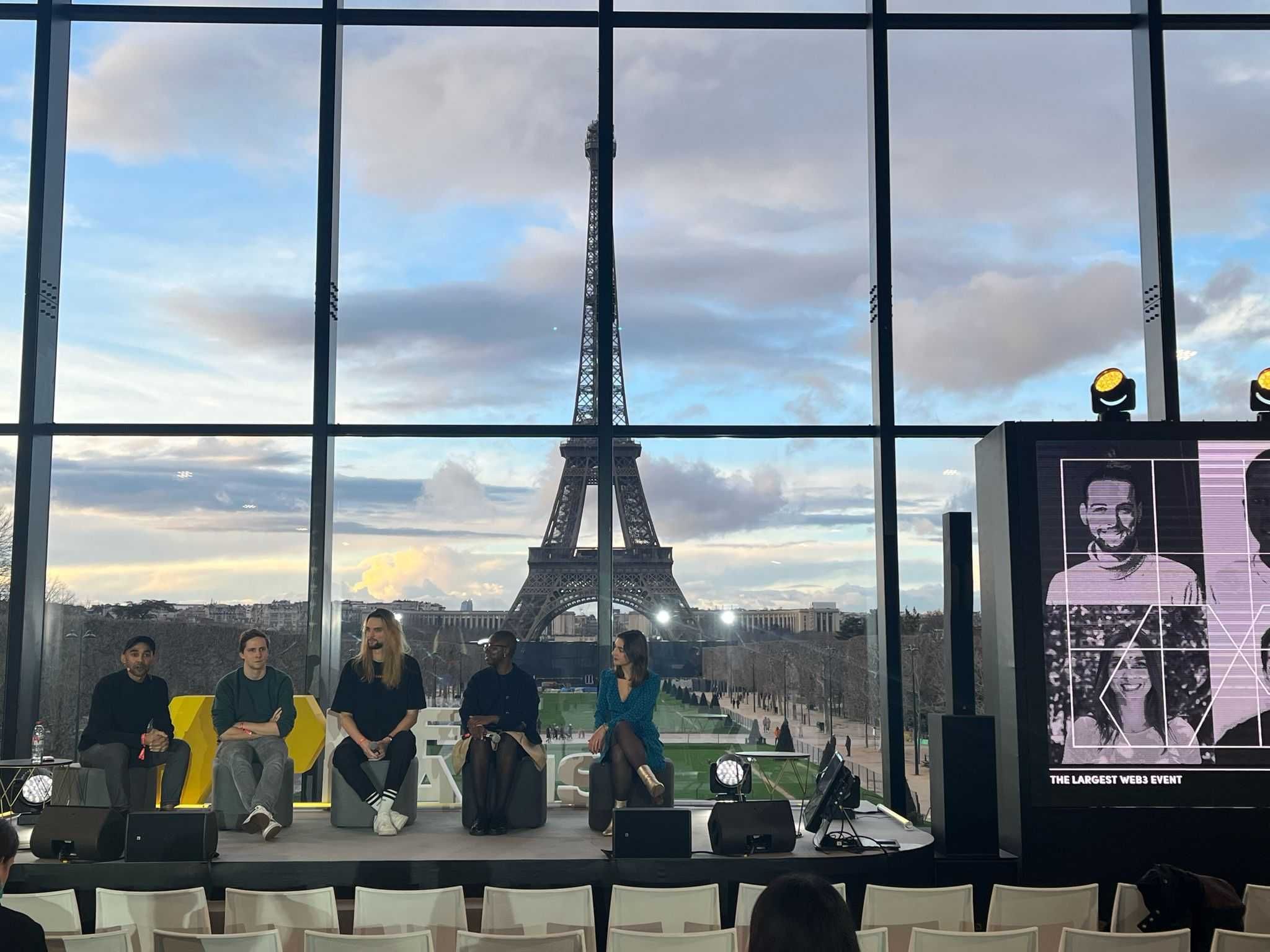 Mariam Kouanda on a panel at NFT Paris with the Eiffel Tower visible behind the stage